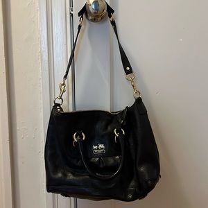 Coach women’s black purse with a purple interior!
